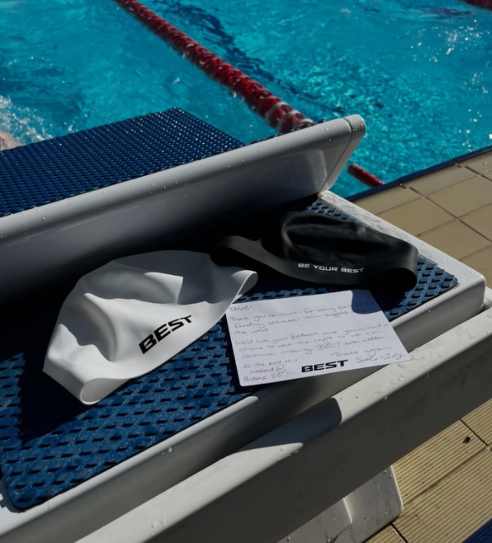 White and black BEST caps on a starting block