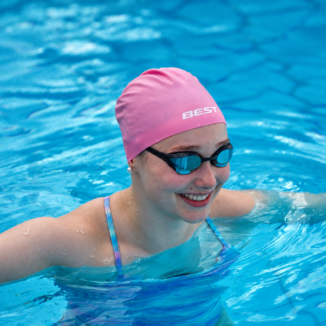 Swimmer wearing the Bubblegum BEST Pastel Performance Dome Cap