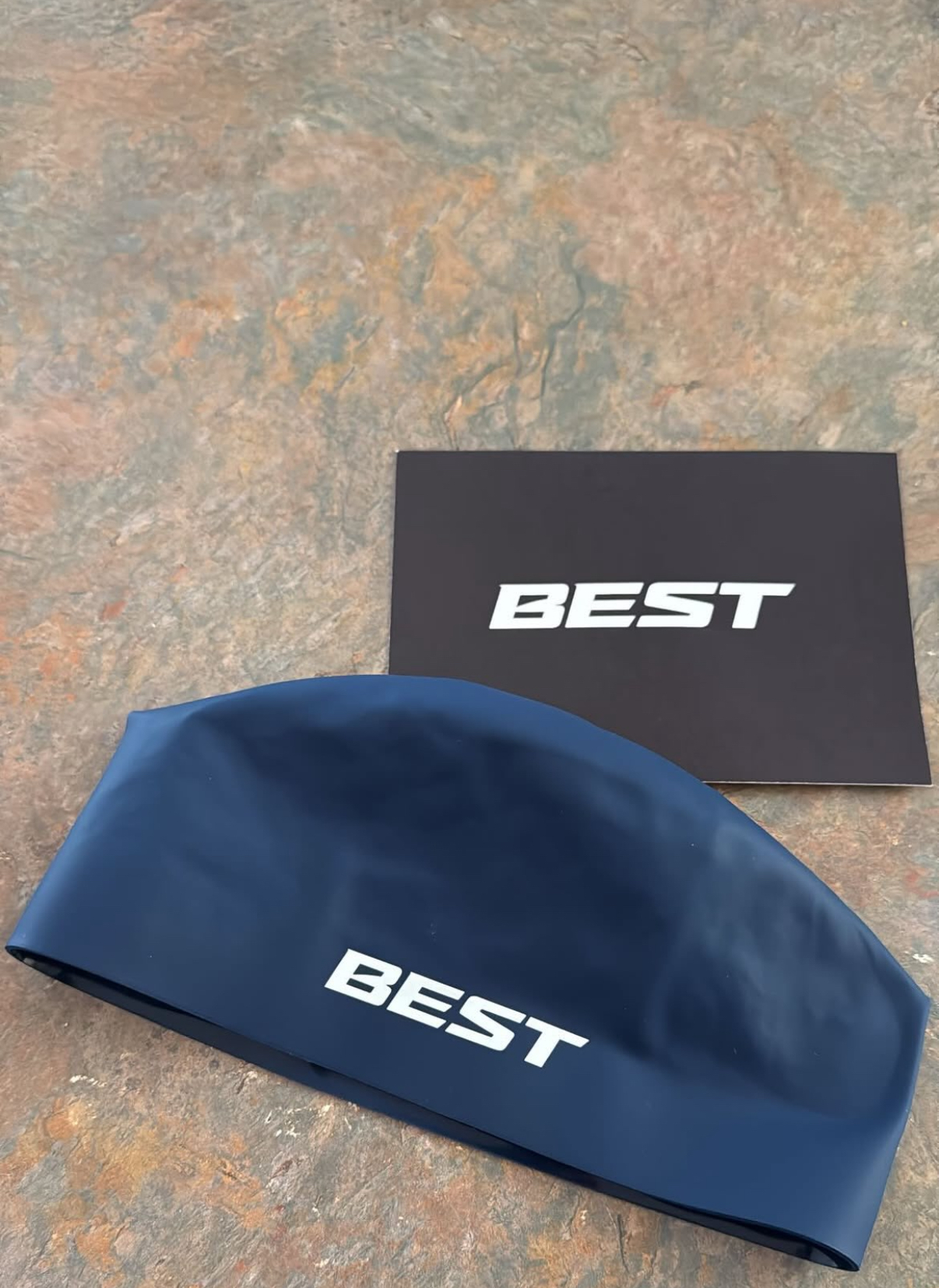Navy BEST cap with a black BEST card